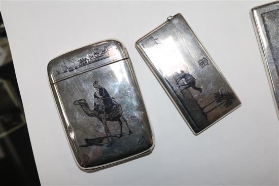 Two continental white metal and niello card cases and a similar cigarette case.